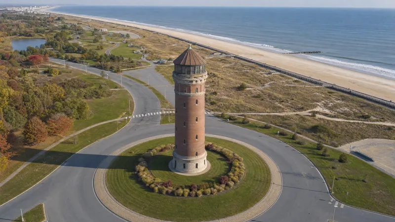 Elevated water tower above a shoreline park